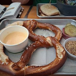 Large soft pretzel with cheese sauce, stoneground mustard and pickled onions/pickles Large soft pretzel with cheese sauce, stoneground mustard and pickled onions/pickles