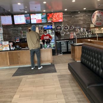 Mountain Mike's Pizza - a man in a restaurant - Pizza Near Me - Aptos, California Mountain Mike's Pizza - a man in a restaurant - Pizza Near Me - Aptos, California