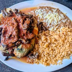 El Molcajete Mexican Restaurant - CHILES POBLANOS: poblano peppers stuffed with cheese, egg batter and fried golden brown, topped w/ grilled steak and salsa ranchera.