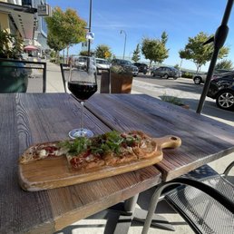 Prosciutto, whipped goat cheese, arugula, with drizzled honey flatbread, with suggested Italian wine.