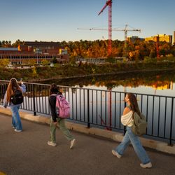 University of Wisconsin-Eau Claire - Students cross the bridge during fall.