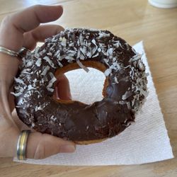 White cake donut with chocolate frosting and coconut