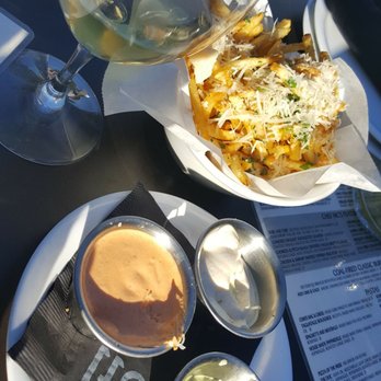 Pitch - Truffle Fries and a glass of white wine on the patio - New American Near Me - Omaha, Nebraska Pitch - Truffle Fries and a glass of white wine on the patio - New American Near Me - Omaha, Nebraska