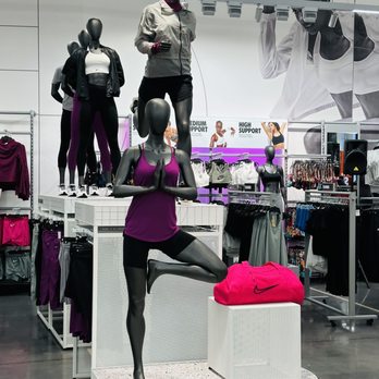 Nike Unite - Mannequins dressed in Nike athletic clothing and accessories are arranged inside a retail store, with promotional posters and clothing racks in the background. - Sports Wear Near Me - Silver Spring, Maryland
