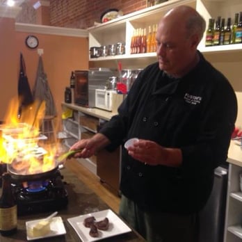 Fustini's Oil & Vinegars - a man cooking in a kitchen - Olive Oil Near Me - Petoskey, Michigan Fustini's Oil & Vinegars - a man cooking in a kitchen - Olive Oil Near Me - Petoskey, Michigan