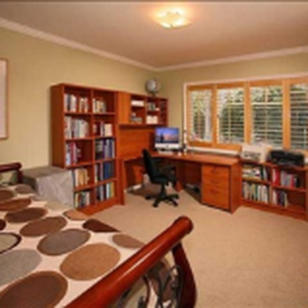 Samuels Construction - a bedroom with a bed, desk and bookshelf - General Contractors Near Me - Pleasant Hill, California