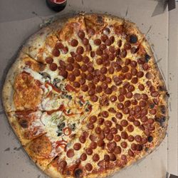Runway 9 - Pepperoni and veggie pizza with soda bottle for size reference
