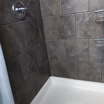 Feeney Construction - a shower with a shower head - Windows Installation Near Me