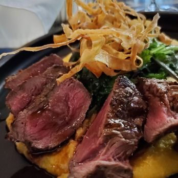 Vintage Year - Venison over sweet potato polenta, with kale and shoestring fries - Steakhouses Near Me - Montgomery, Alabama Vintage Year - Venison over sweet potato polenta, with kale and shoestring fries - Steakhouses Near Me - Montgomery, Alabama
