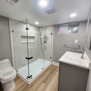 Sibrialf Home Improvement - a bathroom with a shower, toilet, and sink - Plumbing Near Me Sibrialf Home Improvement - a bathroom with a shower, toilet, and sink - Plumbing Near Me