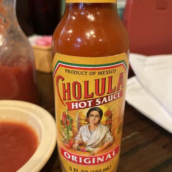El Rancho Nuevo - a bottle of hot sauce on a table - Mexican Near Me - Weldon Spring, Missouri