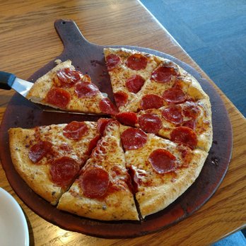 Pizza Hut - a slice of pepperoni pizza on a cutting board - Pizza Near Me - Laredo, Texas