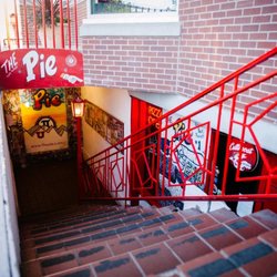 The Pie Pizzeria - Underground - The iconic stairway entrance to The Pie Pizzeria Underground, located just steps from the University of Utah campus. Follow the red railings