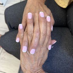 Unnatural pink tone for my skin, with visible leftover dip product around the cuticles. Close-up shows uneven application and poor cleanup. Unnatural pink tone for my skin, with visible leftover dip product around the cuticles. Close-up shows uneven application and poor cleanup.