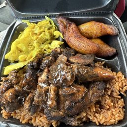 Jerk chicken, jollof rice, plantains, and curry cabbage Jerk chicken, jollof rice, plantains, and curry cabbage