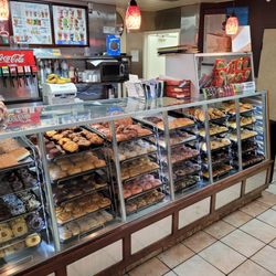 Yum Yum Donuts - Clean inside, full racks of fresh donuts.