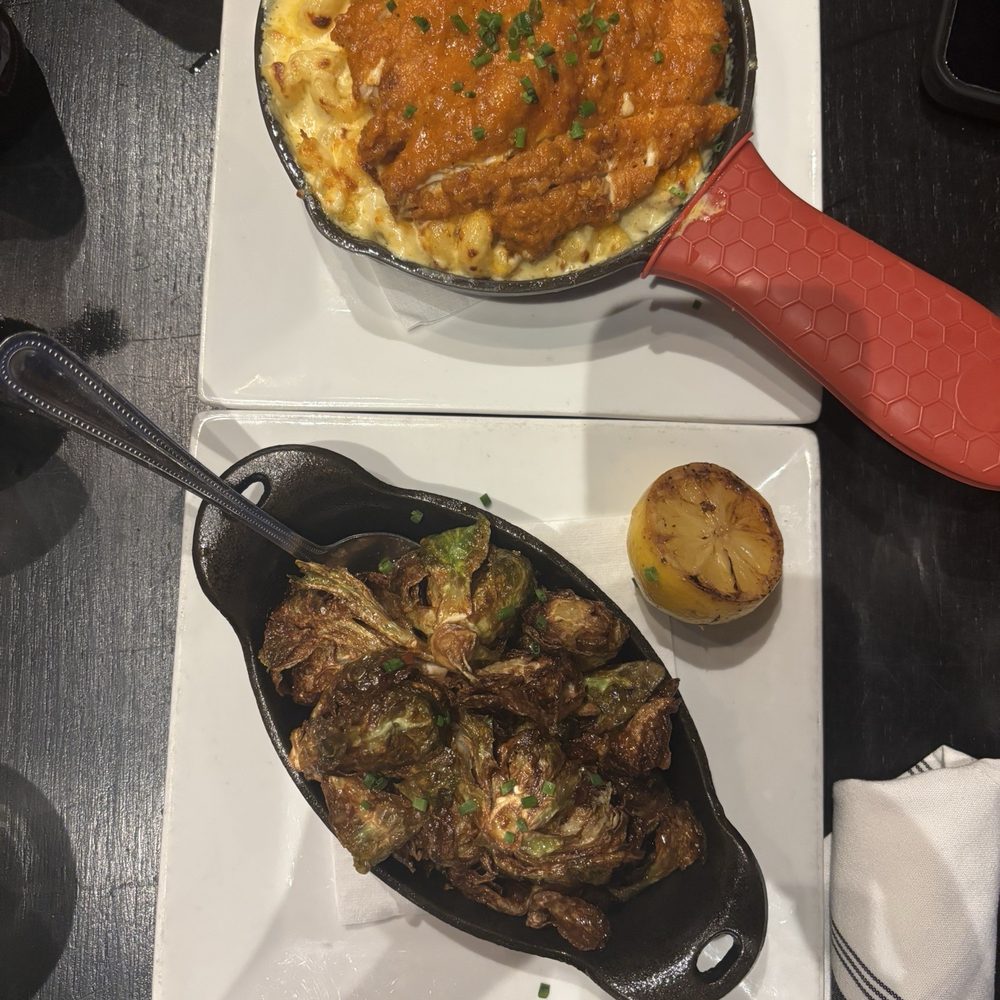 The Stillery - Top: Mac and Mac n' Cheese Topped with Hot Chicken Bottom: Crispy Brussel Sprouts - New American Near Me - Nashville, Tennessee The Stillery - Top: Mac and Mac n' Cheese Topped with Hot Chicken Bottom: Crispy Brussel Sprouts - New American Near Me - Nashville, Tennessee