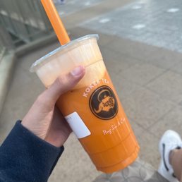 a person holding a drink in their hand
