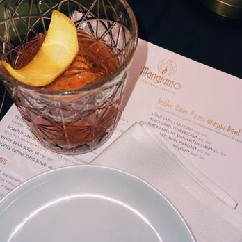 Mangiamo - WAGYU OLD FASHIONED a wagyu washed woodford rye with walnut bitters orange wheel and smoked liquour - Italian Near Me - Grand Rapids, Michigan Mangiamo - WAGYU OLD FASHIONED a wagyu washed woodford rye with walnut bitters orange wheel and smoked liquour - Italian Near Me - Grand Rapids, Michigan