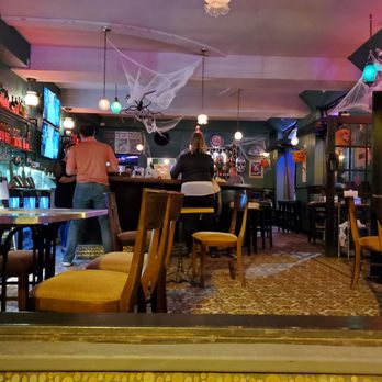 Barrio - a view of a bar with a spider web hanging from the ceiling - Beer Bar Near Me - Clayton, Missouri
