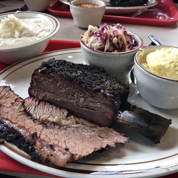 Killen's Barbecue - Brisket, beef rib, coleslaw, potato salad, and bowl of banana pudding. - Barbeque Near Me - Pearland, Texas