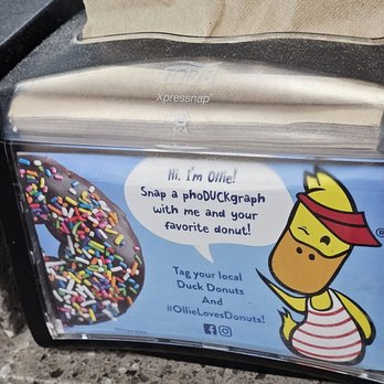 Duck Donuts - Ollie is even on the napkin dispenser. - Donuts Near Me - Roanoke, Virginia