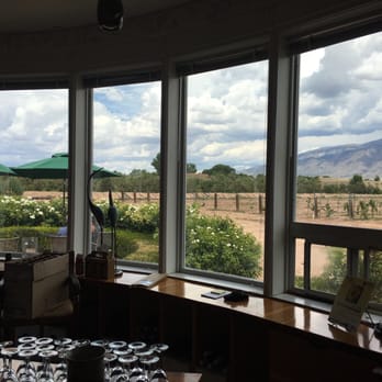 Corrales Winery - a view of a vineyard through a window - Wineries Near Me - Corrales, New Mexico