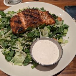 Caesar salad with salmon and dressing on side Caesar salad with salmon and dressing on side