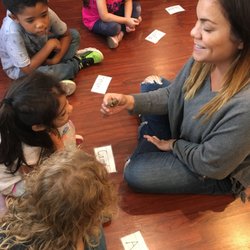 Pear Tree Community School - TK/K students examine a snail in zoology with Ms. Romy.