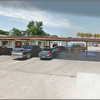 Moo Moo - a parking lot with cars parked in it - Burgers Near Me - Victoria, Texas