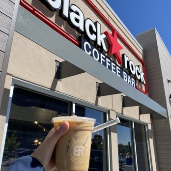 Black Rock Coffee Bar - a hand holding a cup of coffee - Coffee & Tea Near Me - Denver, Colorado