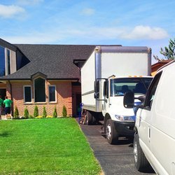 Tank Team Movers - Exterior shot of Tank Team Movers unloading a 26' moving truck and cargo van in Lakeshore, Ontario.