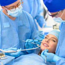 Advanced Oral And Maxillofacial Surgery - A skilled oral surgeon performs complex maxillofacial surgery in a state-of-the-art surgical theater.