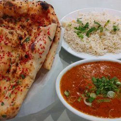 Mehfil Indian Cuisine & Bar - Garlic naan, Chicken Tikka Masala. Note the diced garlic is red in color. There are also herb toppings. Very good presentation.
