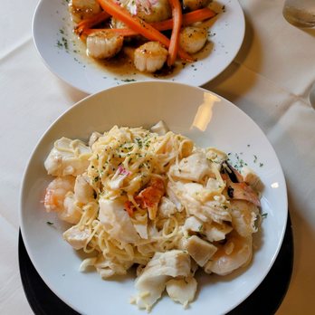 Ottos on the River - Foreground is the Seafood Scampi Background is the Scallops Entree - Seafood Near Me - Augusta, Maine Ottos on the River - Foreground is the Seafood Scampi Background is the Scallops Entree - Seafood Near Me - Augusta, Maine