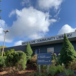 Exterior outside entrance of West Slope Community Library - Front of West Slope Community Library building in spring, with a lot of fluffy white clouds overhead. - Portland, Oregon Exterior outside entrance of West Slope Community Library - Front of West Slope Community Library building in spring, with a lot of fluffy white clouds overhead. - Portland, Oregon