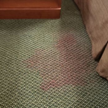 White River Inn and Suites - Large carpet stain between beds - Hotels Near Me - Hartford, Vermont