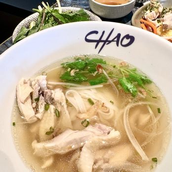Chao - Phở Gà. Same poached white meat chicken and rich broth served w the Cơm Gà + plate of culanto, basil, cilantro. - Asian Fusion Near Me - Honolulu, Hawaii