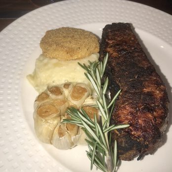 A Land Remembered - New York Strip (16 oz.) with Garlic Mashed Potatoes & fried green tomato - Steakhouses Near Me - Orlando, Florida