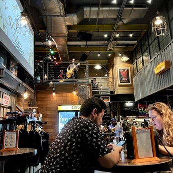 SingleCut Beersmiths - a man and a woman sitting at a bar - Breweries Near Me - Astoria, New York