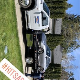 Vehicle on flatbed tow truck.