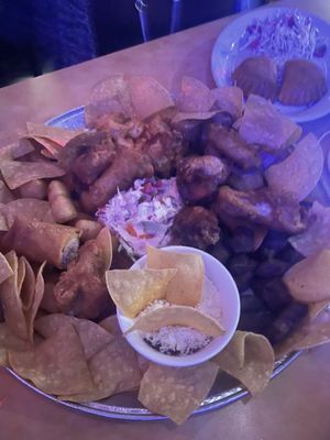 Photo of Islas Del Caribe Restaurant - Miami, FL, US. Picadera, includes beef, pork, chicken, yuca frita, chorizo, tostones, cabbage salad, been dip.