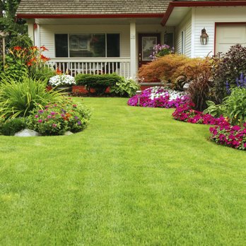 Colonial Greencare - a front yard with a lawn and flower bed - Lawn Services Near Me Colonial Greencare - a front yard with a lawn and flower bed - Lawn Services Near Me