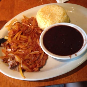 Coco's Cuban - Bistec palomilla with black beans and yellow rice. - Cuban Near Me - Cumming, Georgia Coco's Cuban - Bistec palomilla with black beans and yellow rice. - Cuban Near Me - Cumming, Georgia