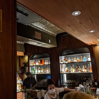 The Bluebird Bar - a bartender at the bar - New American Near Me - West Newton, Massachusetts