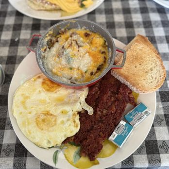 Baci Trattoria - Grits all the way, corned beef hash & eggs over medium. - Italian Near Me - Vero Beach, Florida