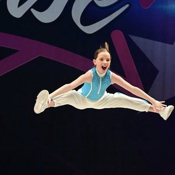 Do The Most Dance - one of our junior members jumping for joy onstage at one of our competitions - Dance Studios Near Me - Los Angeles, California Do The Most Dance - one of our junior members jumping for joy onstage at one of our competitions - Dance Studios Near Me - Los Angeles, California