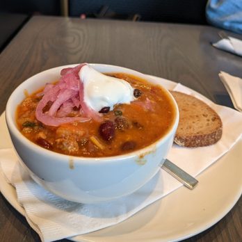 Impact Kitchen - a bowl of chili soup and a slice of bread - Gluten-Free Near Me - Toronto, Ontario
