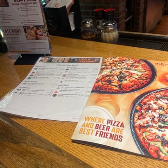 Old Chicago Pizza + Taproom - Menus, sitting at end of bar. - Pizza Near Me - Loveland, Colorado Old Chicago Pizza + Taproom - Menus, sitting at end of bar. - Pizza Near Me - Loveland, Colorado