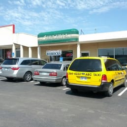 a parking lot with cars parked in front of it